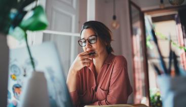 Woman looking at computer reviewing details